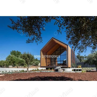 Two-story modular tiny house with steel structure, prefabricated luxury villa design, featuring large windows and modern exterior.