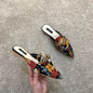 Women's designer floral embroidered slippers with metal chains, closed toe slides, flats, low heels, and flip flop style sandals.