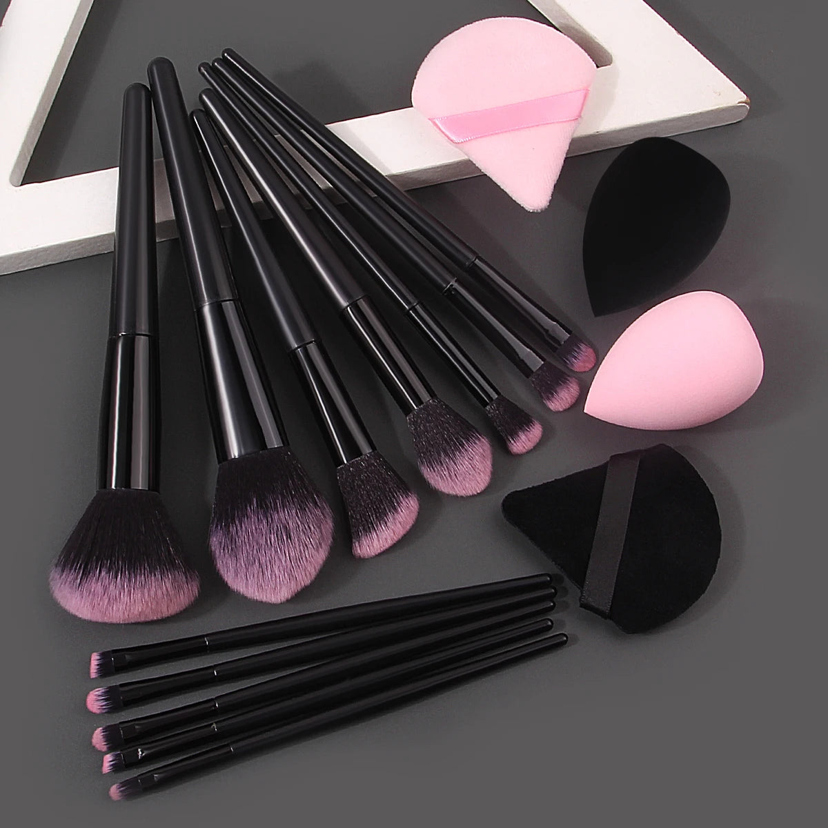 Set of 12 soft makeup brushes, 4 beauty eggs, and a triangular powder puff, all portable and practical beauty tools.