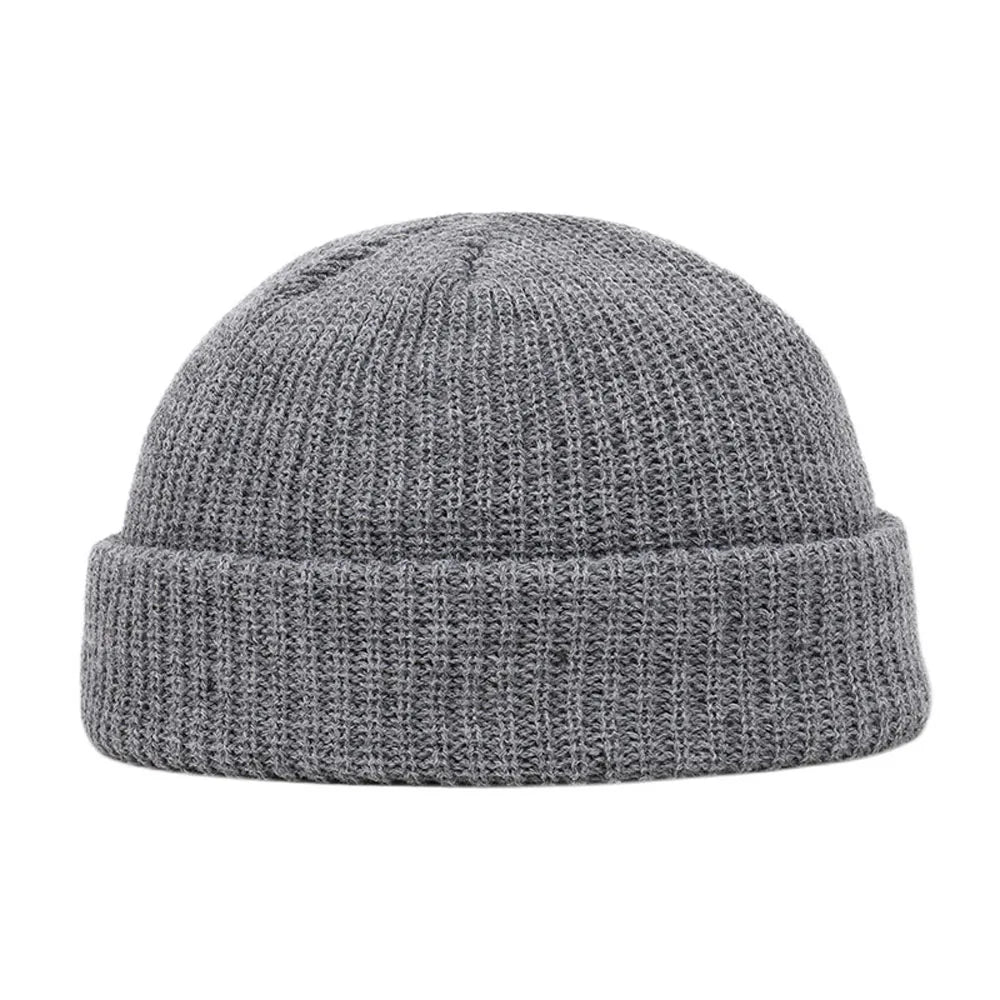 Navy blue knitted beanie cap for men and women, warm wool style, simple and solid, suitable for autumn and winter wear.
