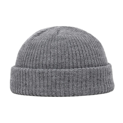 Navy blue knitted beanie cap for men and women, warm wool style, simple and solid, suitable for autumn and winter wear.