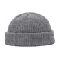 Navy blue knitted beanie cap for men and women, warm wool style, simple and solid, suitable for autumn and winter wear.