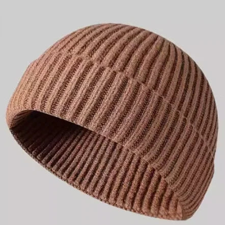 Navy blue knitted beanie cap for men and women, warm wool hat with simple stylish design for autumn and winter wear.