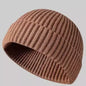Navy blue knitted beanie cap for men and women, warm wool hat with simple stylish design for autumn and winter wear.