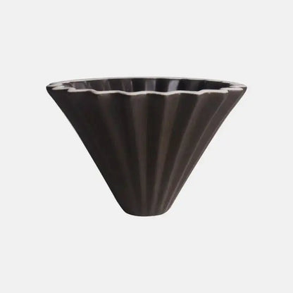 Handmade orange ceramic pour-over coffee dripper with flower-shaped funnel for drip coffee brewing.