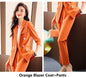 Women's orange business suit with formal jacket and trousers, stylish professional attire for women by BackupMyFilesNow.com
