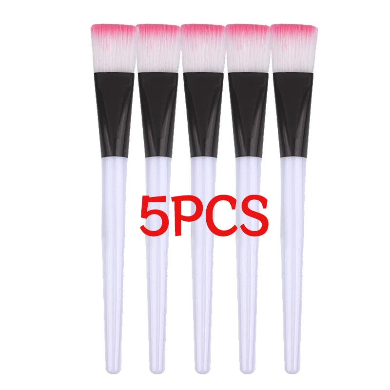 Pink facial masks brushes set with soft hair applicators for DIY face masks, makeup, and spa facial care tools.