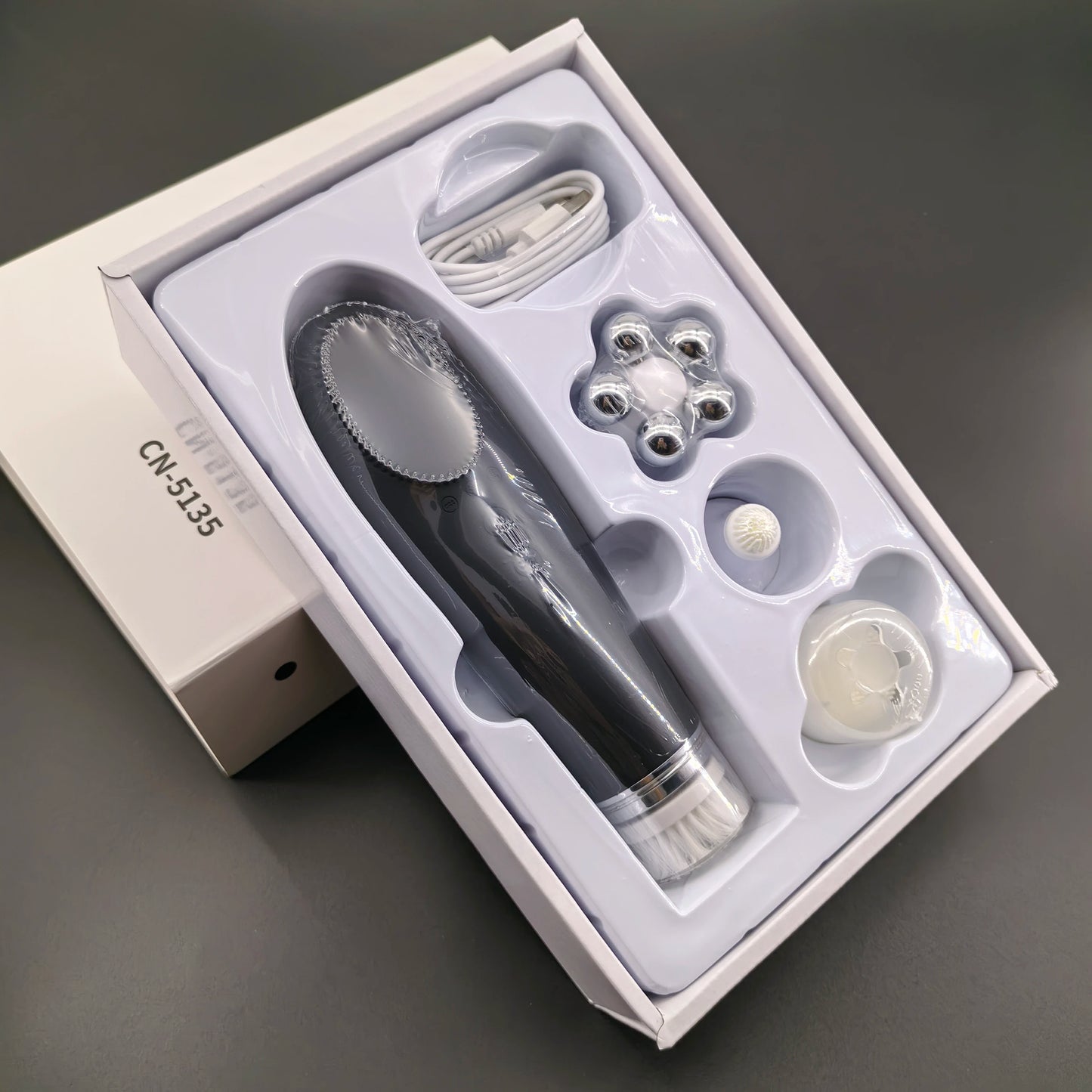 Pink BackupMyFilesNow.com 4-in-1 facial skin lifting device with electric silicone face brush for deep cleansing and skin toning.