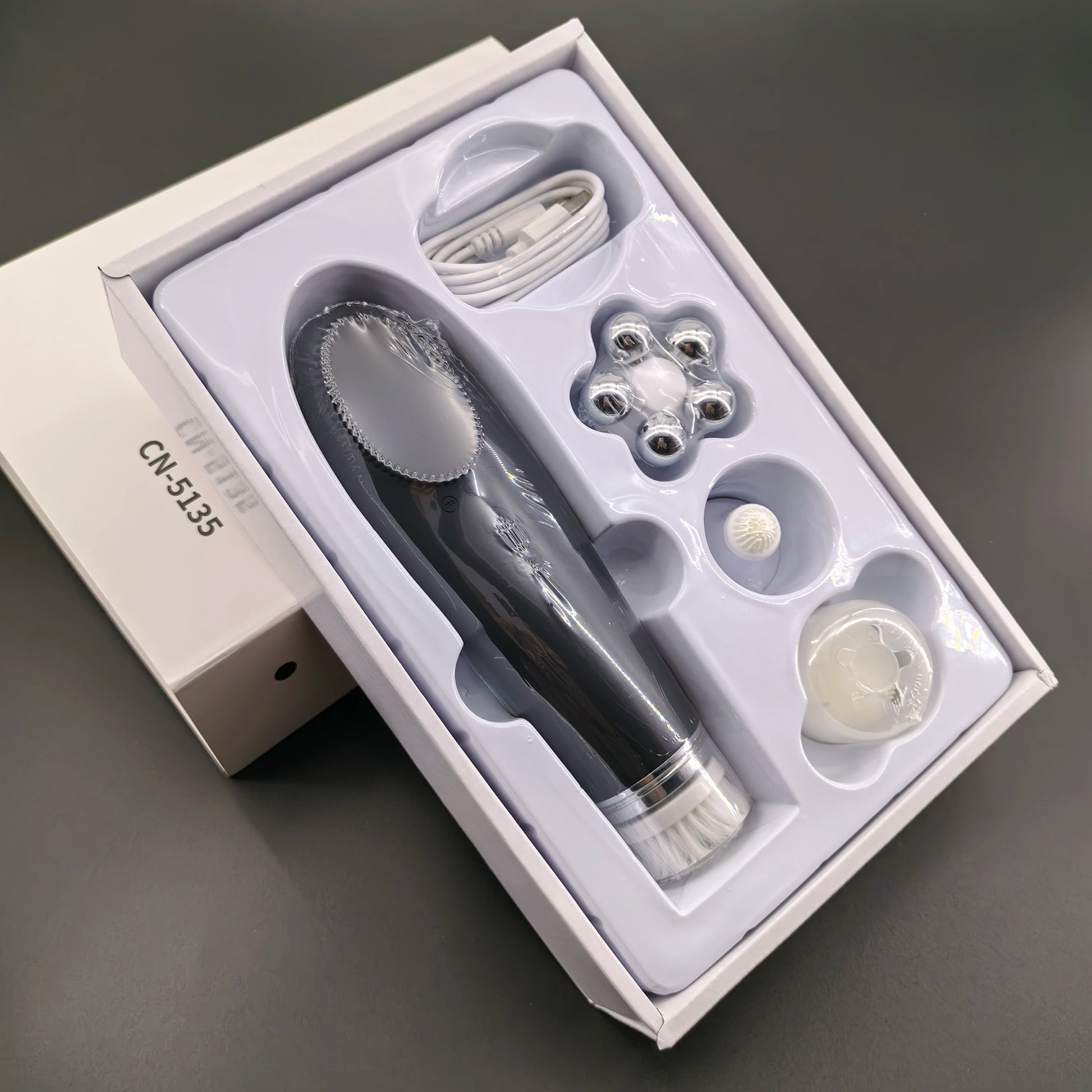 Pink BackupMyFilesNow.com 4-in-1 facial skin lifting device with electric silicone face brush for deep cleansing and skin toning.