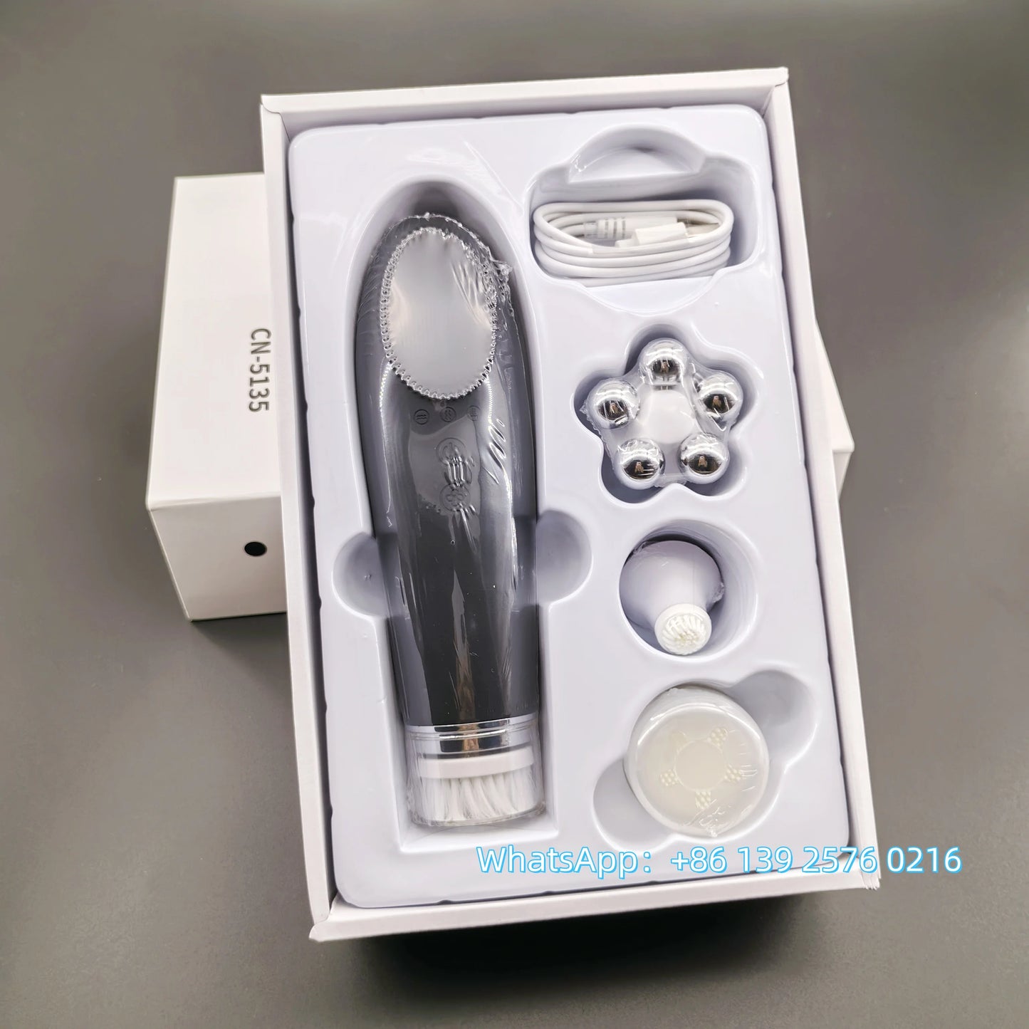 Pink BackupMyFilesNow.com 4-in-1 facial skin lifting device with electric silicone face brush for deep cleansing and skin rejuvenation.