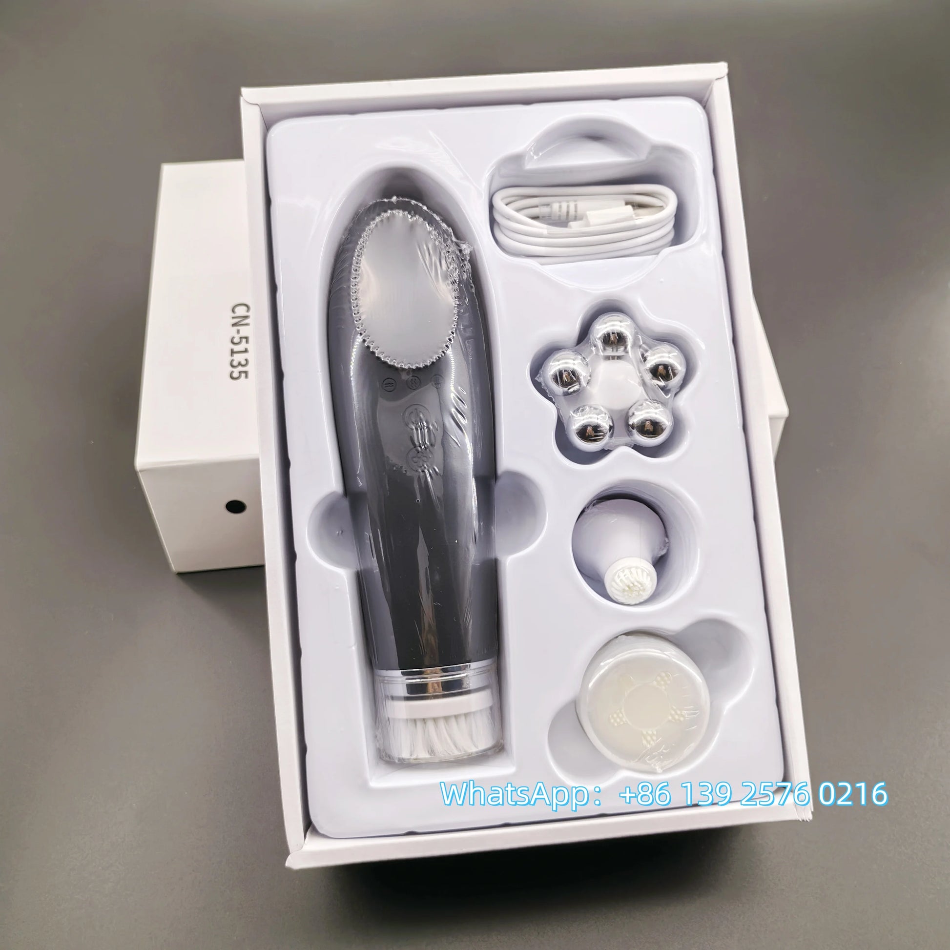 Pink BackupMyFilesNow.com 4-in-1 facial skin lifting device with electric silicone face brush for deep cleansing and skin rejuvenation.