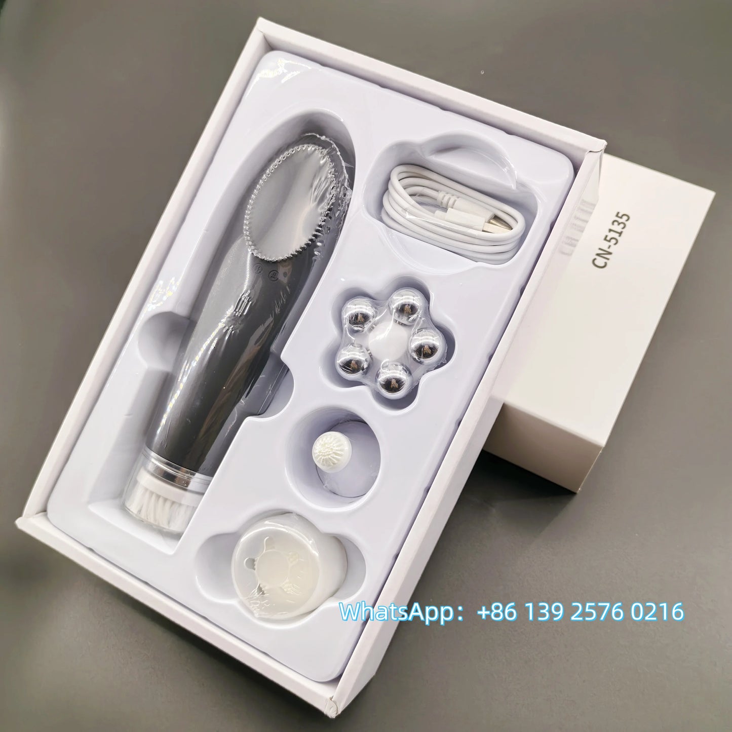 Pink BackupMyFilesNow.com 4-in-1 facial skin lifting device with electric silicone face brush for deep cleansing and skin rejuvenation.