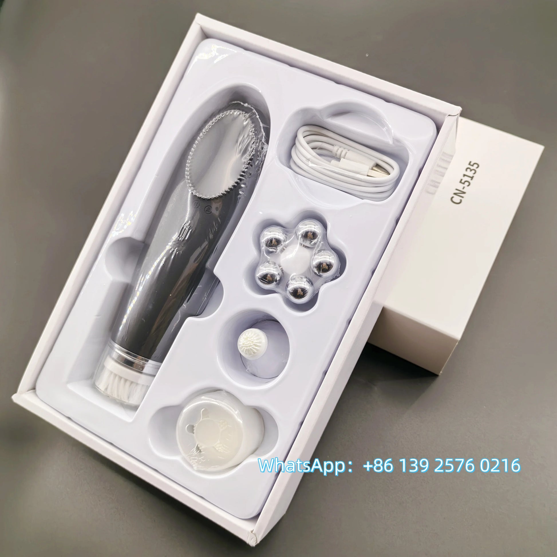 Pink BackupMyFilesNow.com 4-in-1 facial skin lifting device with electric silicone face brush for deep cleansing and skin rejuvenation.