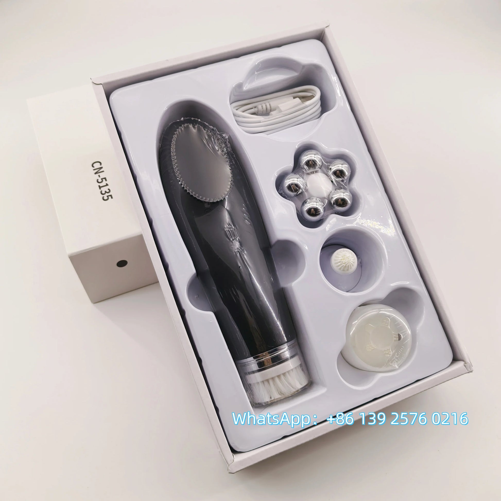 Pink BackupMyFilesNow 4-in-1 facial skin lifting device with electric silicone face brush for deep cleansing and skin care.