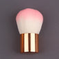 Pink gold makeup brush for foundation, blush, concealer, contour, and highlight with a round angled top for blending.