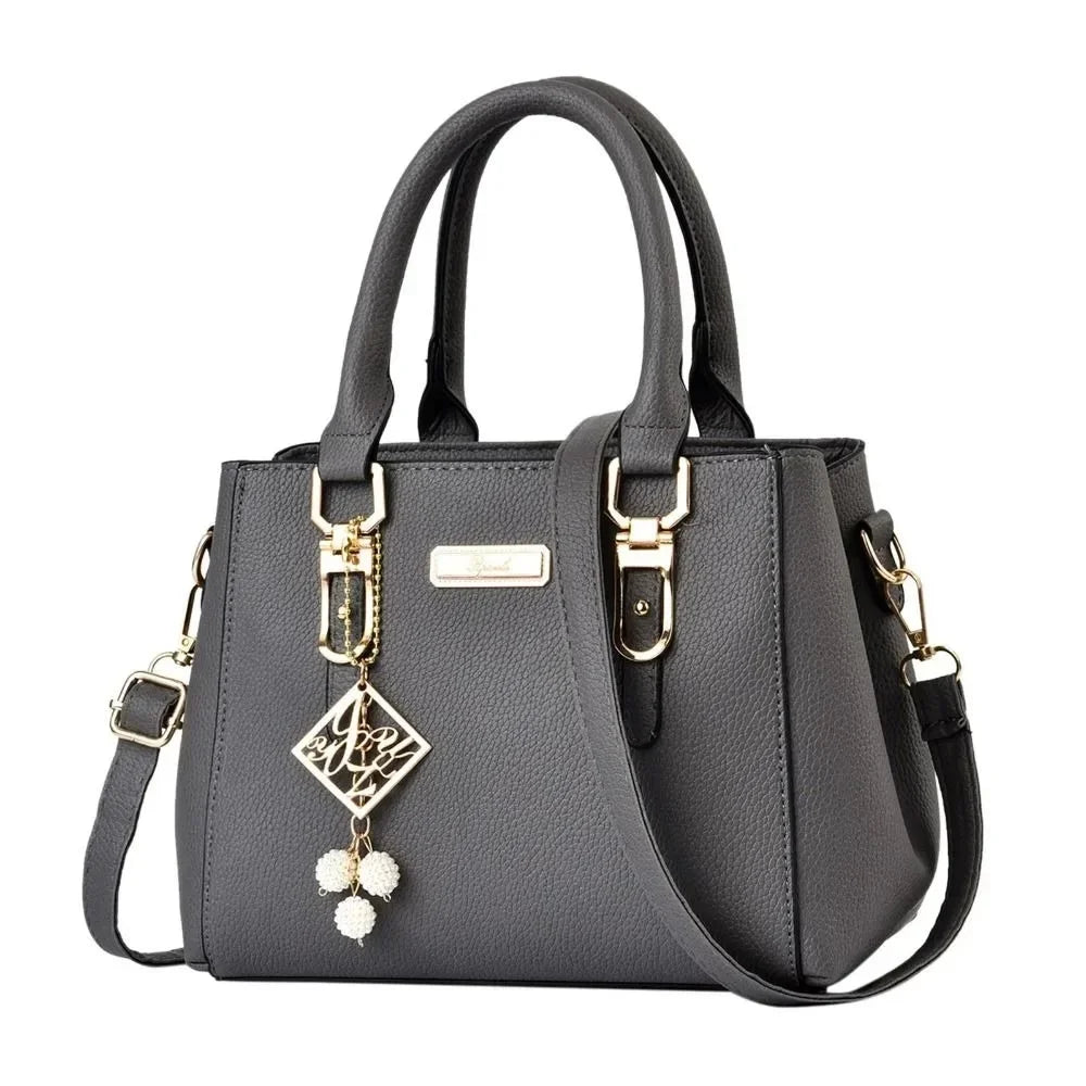 Pink large capacity leather handbag for women, casual shoulder bag with a messenger style, suitable for everyday use.