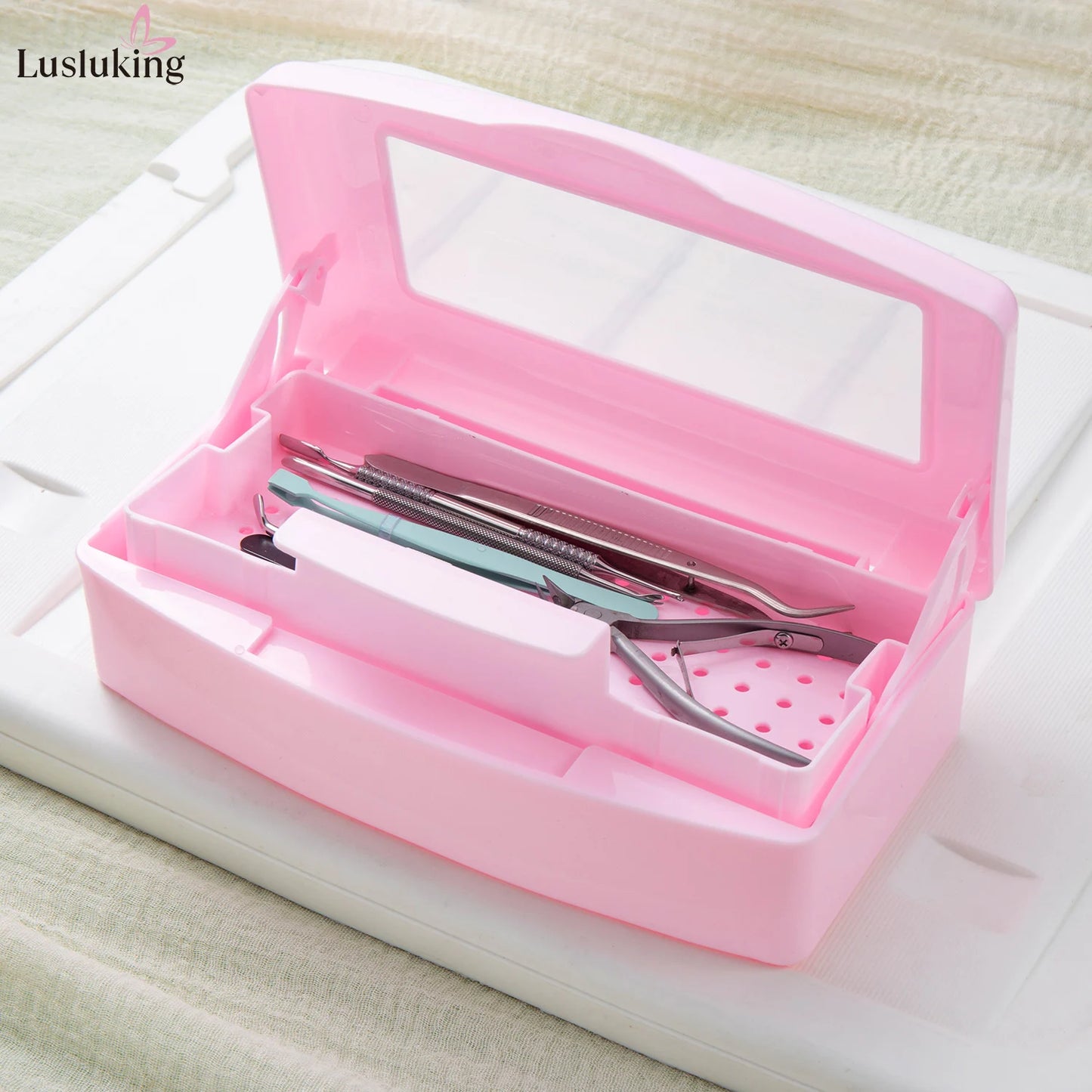 Pink manicure tools sterilizing tray with nail tools inside, disinfection box for cleaning and storage of beauty implements.
