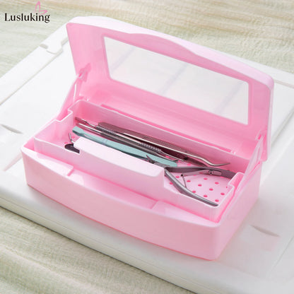 Pink manicure tools sterilizing tray with nail tools inside, disinfection box for cleaning and storage of beauty implements.