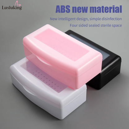 Pink sterilizing tray with manicure tools inside, including nail clippers and files, in a disinfectant storage box for clean nail tools.