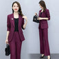Elegant purple women's office suit for work, featuring a tailored blazer and matching trousers, ideal for professional attire.