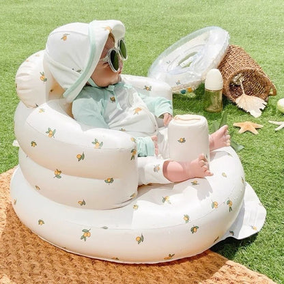 Inflatable rainbow baby chair for dining and bath, designed for infants, with colorful rainbow pattern and soft, secure seating.
