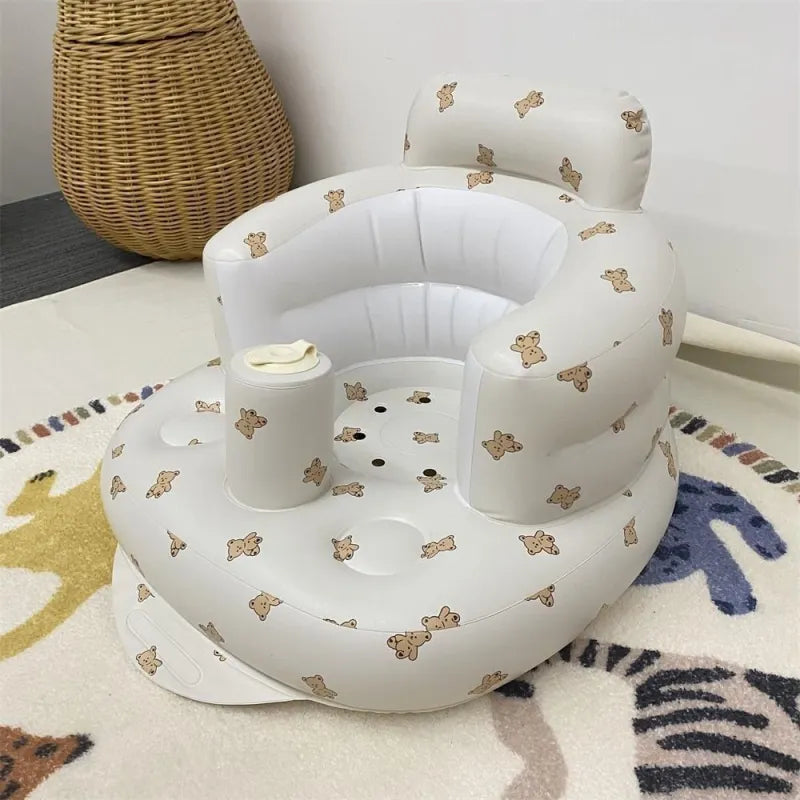 Inflatable baby chair for dining and bath with rainbow design, made by BackupMyFilesNow.com, suitable for infants' comfort and safety.