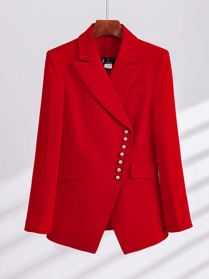 Red two-piece women's business suit with pants, stylish and professional, featuring a tailored blazer and matching trousers.