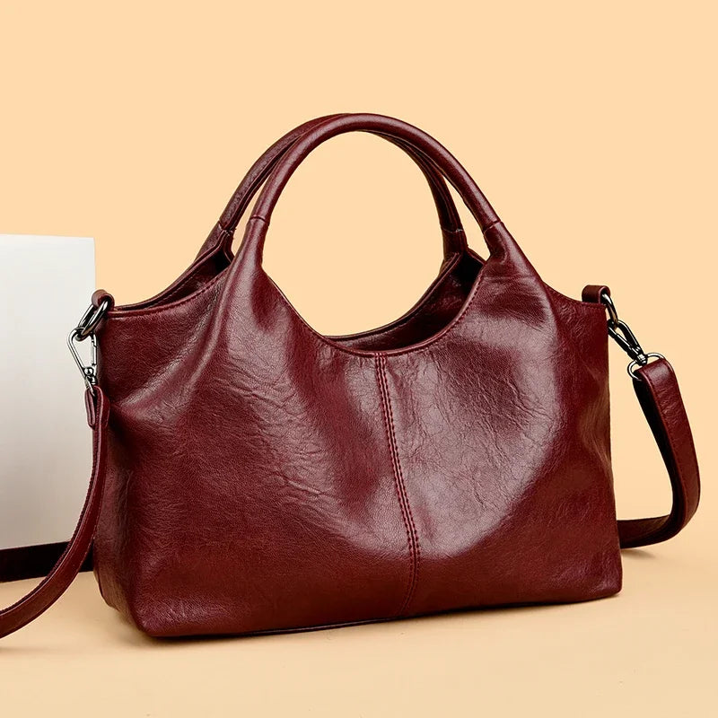 Large red leather women's tote bag with soft, high-quality leather, designed for shoulder or crossbody use, stylish and spacious.