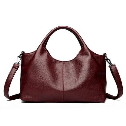 Red large capacity leather tote bag for women featuring soft designer leather, shoulder and crossbody straps, stylish female handbag.