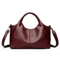 Red large capacity leather tote bag for women featuring soft designer leather, shoulder and crossbody straps, stylish female handbag.