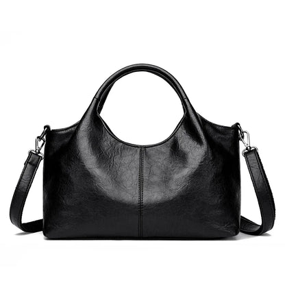 Red leather tote bag for women with large capacity, soft designer leather, shoulder and crossbody style, stylish female handbag.