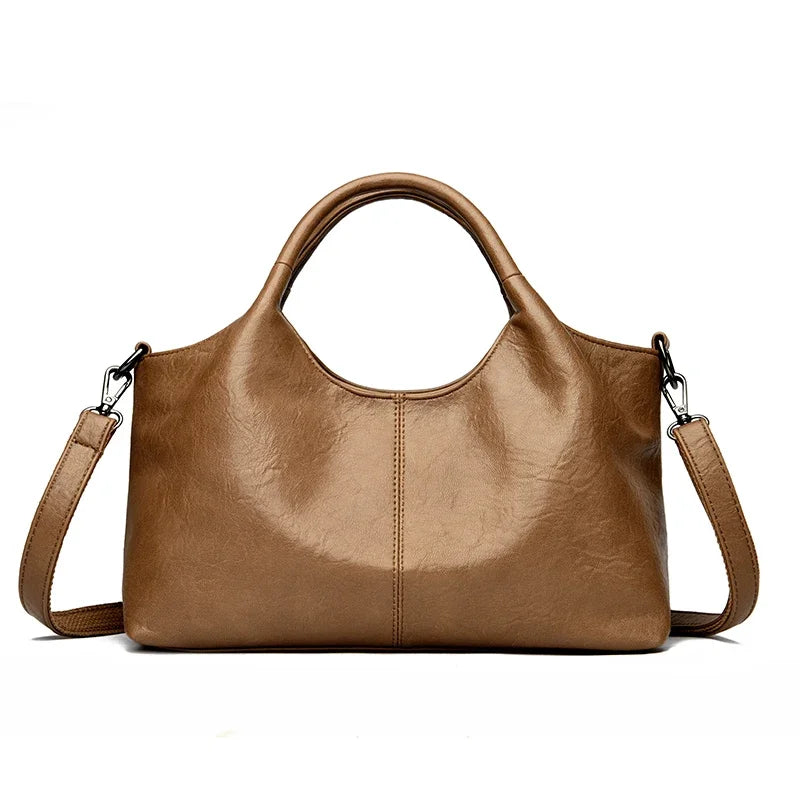 Red leather women’s tote bag with soft, high-quality leather, spacious interior, and shoulder/crossbody straps.