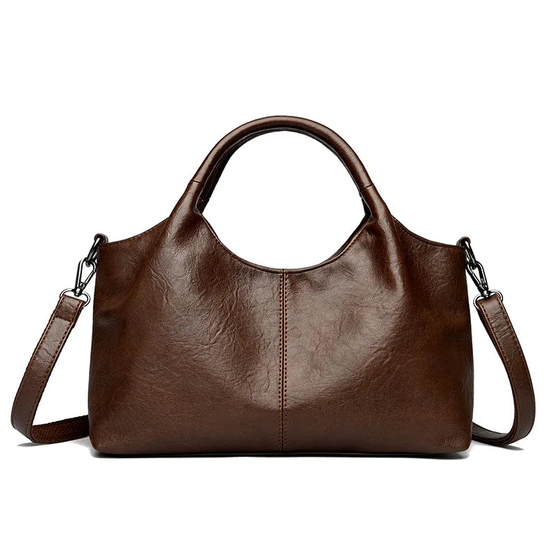 Red leather tote bag for women with shoulder and crossbody straps, featuring a spacious interior and soft, high-quality leather.