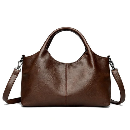 Red leather tote bag for women with shoulder and crossbody straps, featuring a spacious interior and soft, high-quality leather.