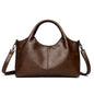 Red leather tote bag for women with shoulder and crossbody straps, featuring a spacious interior and soft, high-quality leather.