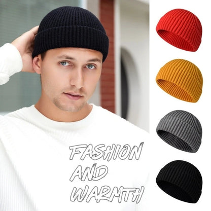 Red knitted beanie cap for men and women, warm wool hat with simple, solid design and trendy style for autumn and winter.