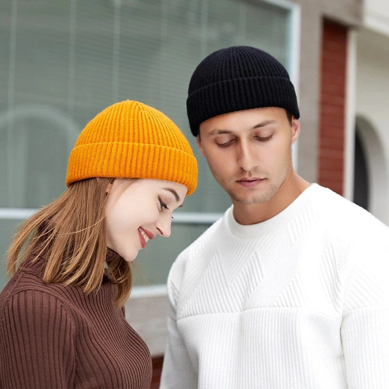 Red knitted beanie cap for men and women, warm wool hat with simple, solid design, perfect for autumn and winter fashion.