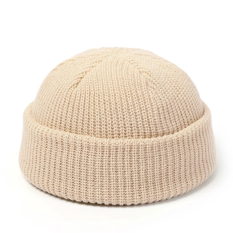 Red knitted beanie hat for men and women, warm wool cap with simple, solid design, perfect for autumn and winter fashion.
