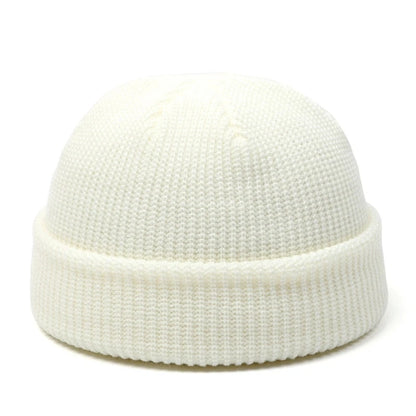 Red knitted beanie hat for men and women, warm wool cap with simple, solid design perfect for autumn and winter fashion.