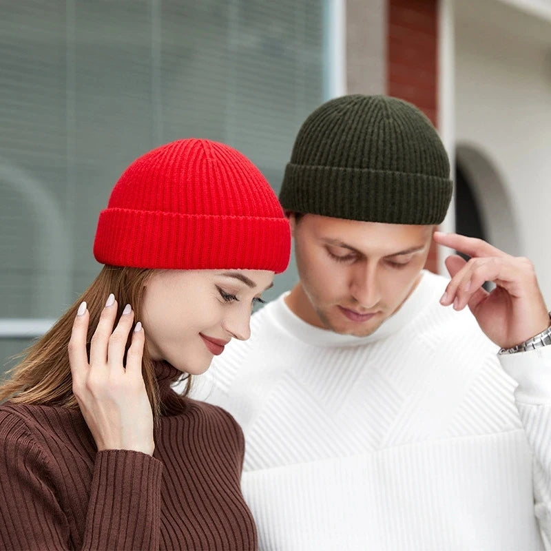 Red knitted wool beanie hat for men and women, featuring a simple, warm, and trendy skull cap design for autumn and winter.