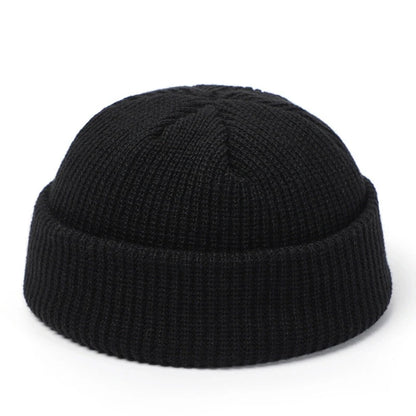 Red knitted beanie cap for men and women, warm woolen skullie hat with simple, solid design for autumn and winter fashion.