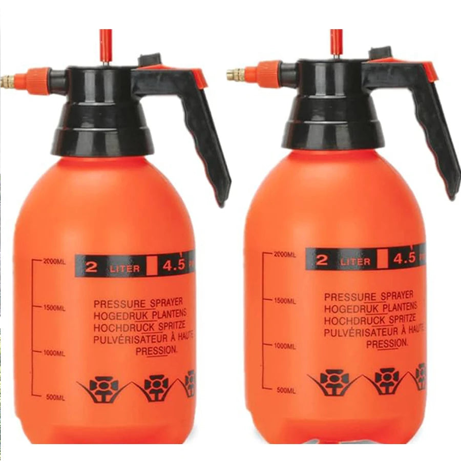 Red watering can with a spray nozzle for indoor plants, garden irrigation, and watering flowers at home.