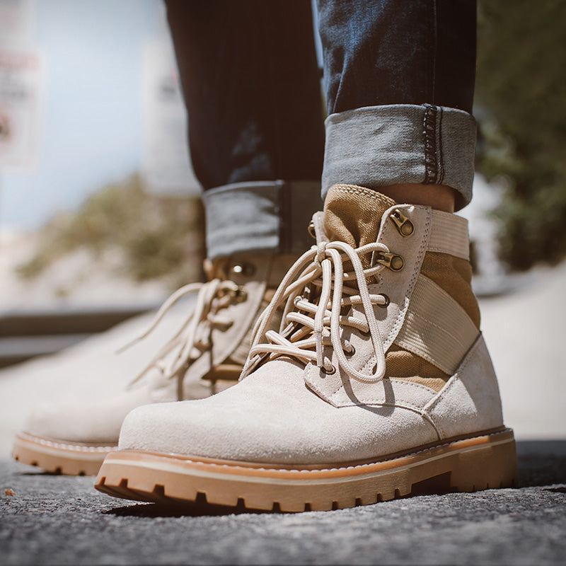 Men’s mid-top desert high-top work boots in sand color, durable leather construction with rugged sole for tough work conditions.