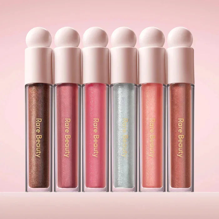 Rare Beauty liquid blush and contouring bronzer with a glossy liquid lipstick and highlighter in a vibrant makeup set.