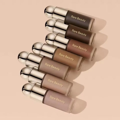 Rare Beauty liquid blush, highlighter, contour, bronzer, and lip gloss set with various shades and sleek packaging.