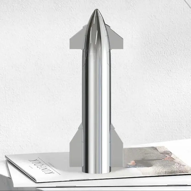 Silver SpaceX Starship rocket model by BACKUPMYFILESNOW.COM, featuring metallic texture, desktop display, with Dragon spacecraft and Falcon rocket.
