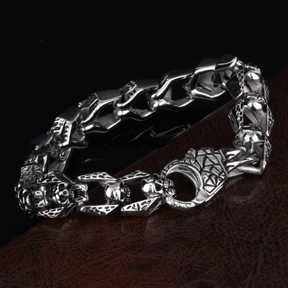 Stainless steel punk skull bracelet with bold design, featuring metallic links and skull accents, on a neutral background.
