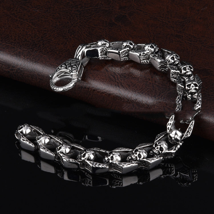 Stainless steel punk skull bracelet with edgy design, featuring detailed skull motifs and a bold, modern style.