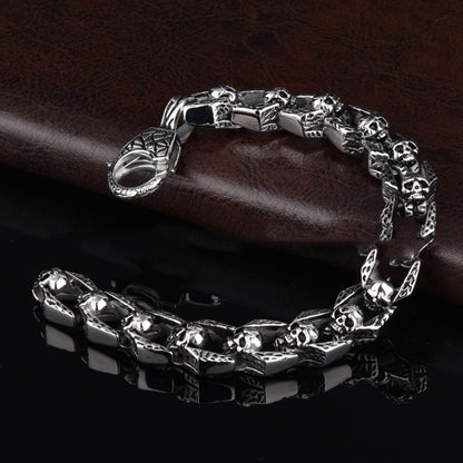 Stainless steel punk skull bracelet with edgy design, featuring detailed skull motifs and a bold, modern style.