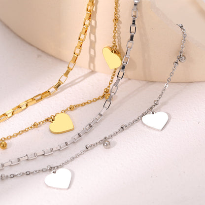 Couple's bracelet with double heart vintage design, featuring intertwined hearts and intricate metalwork, symbolizing love and connection.